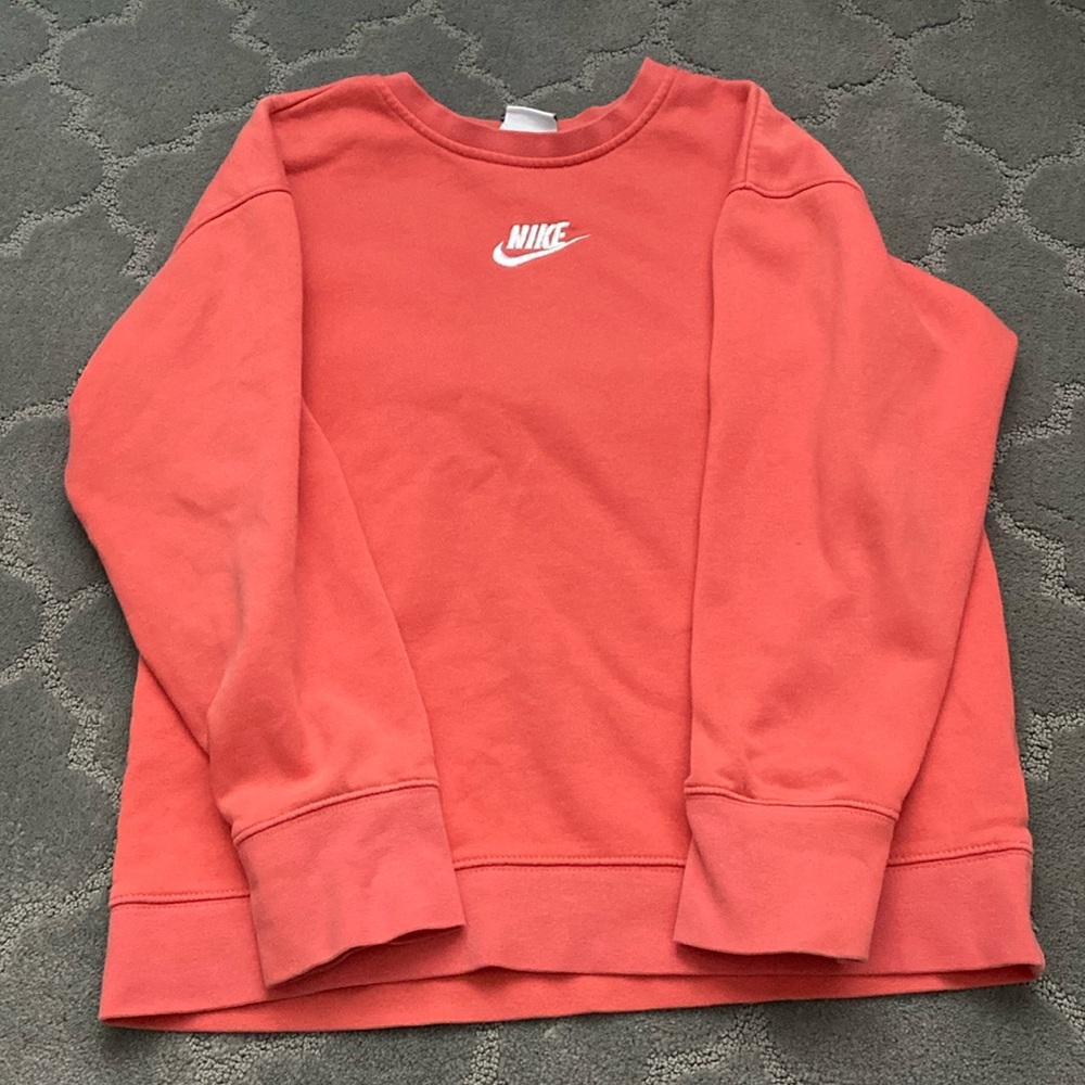 A girls Nike sweatshirt. A little worn but in good condition and no tears.
